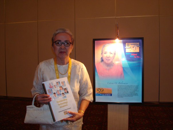 Lety Belarmino holding an book next to an article about her